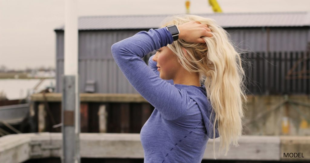 Young woman holding up her hair