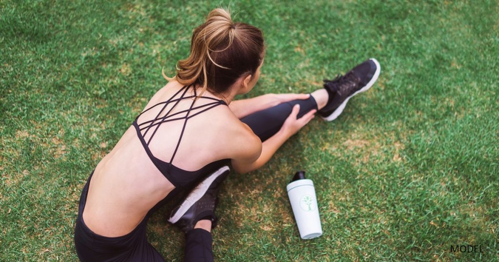 Woman stretching on grass