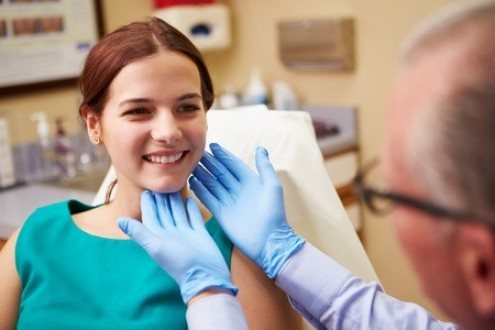 Doctor touching patient's face