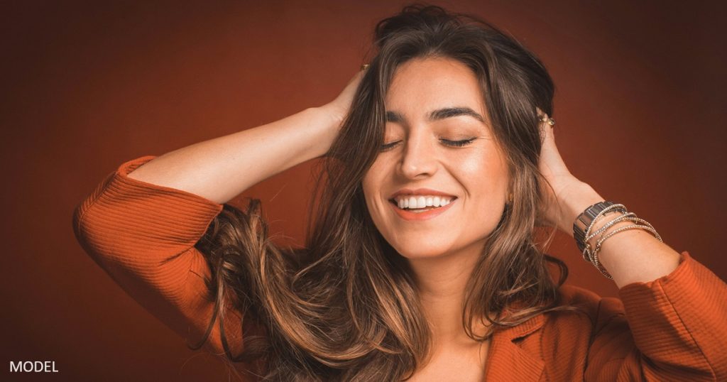 Young woman with hands in her hair