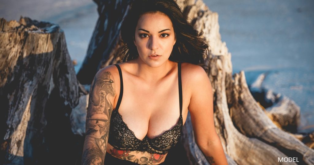 Woman with tattoos looking at camera