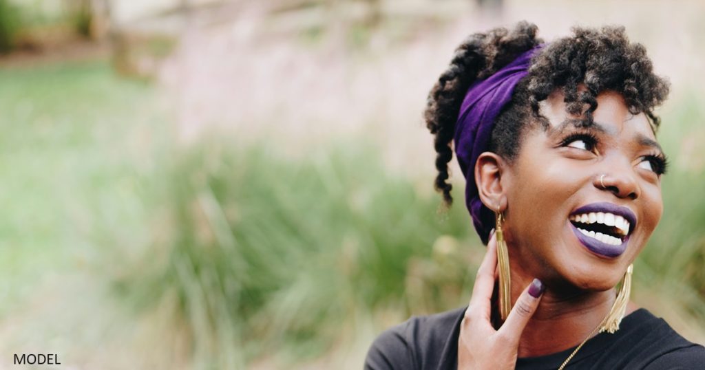 Black woman turning away and smiling