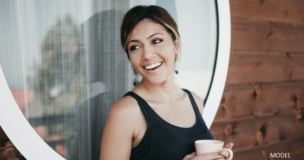 Woman smiling with cup of coffee