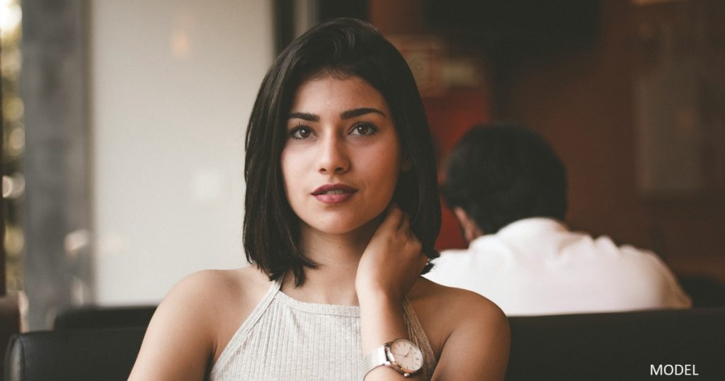 Woman (model) wondering how long breast implants last